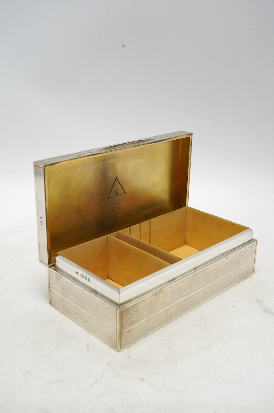 A George V engine turned silver mounted rectangular cigarette box, Padgett & Braham Ltd, London, 1926, 17.8cm. Condition - fair to good